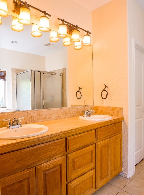 bathroom with vanity, tile patterned floors, and a shower with shower door