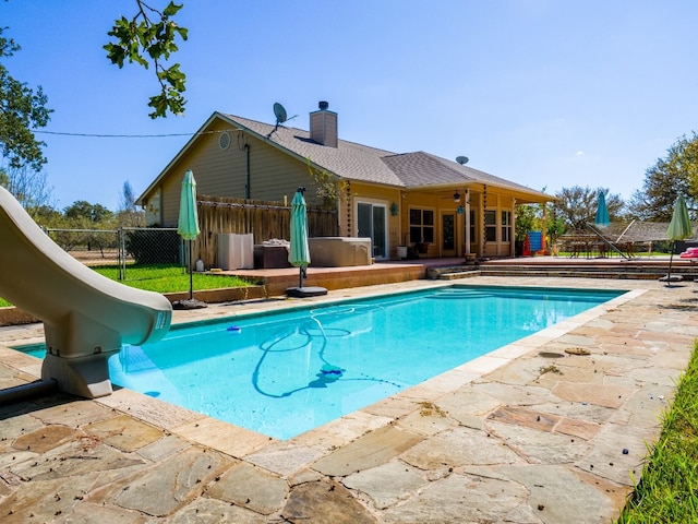 view of pool featuring a water slide, a patio area, and ceiling fan