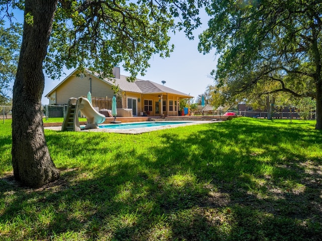 back of house with a yard and a patio area