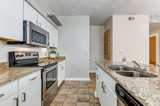 1201 Grove Blvd Unit 2403, Austin, TX 78741 - kitchen with stainless steel appliances, visible vents, a sink, baseboards, and tasteful backsplash