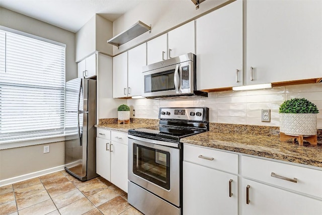 1201 Grove Blvd Unit 2403, Austin, TX 78741 - kitchen featuring white cabinets, stainless steel appliances, backsplash, and a healthy amount of sunlight