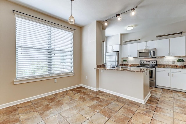 1201 Grove Blvd Unit 2403, Austin, TX 78741 - kitchen with white cabinets, decorative light fixtures, baseboards, and stainless steel appliances