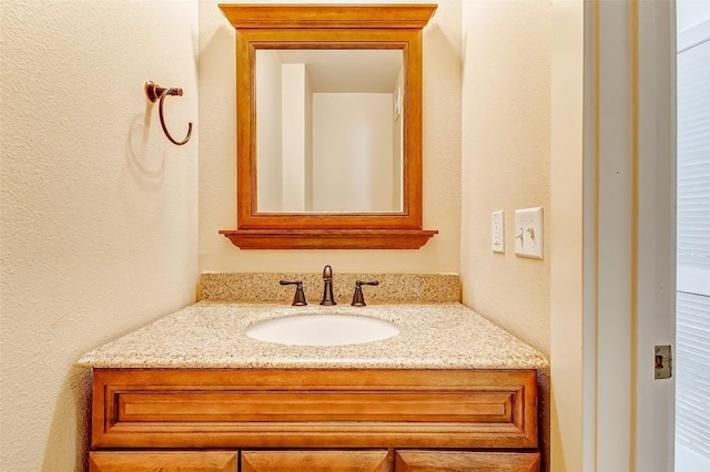 1201 Grove Blvd Unit 2403, Austin, TX 78741 - bathroom with a textured wall and vanity