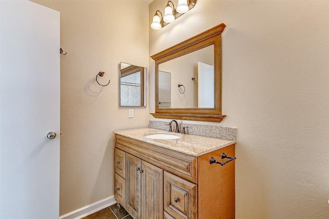 1201 Grove Blvd Unit 2403, Austin, TX 78741 - bathroom featuring baseboards, vanity, and tile patterned flooring