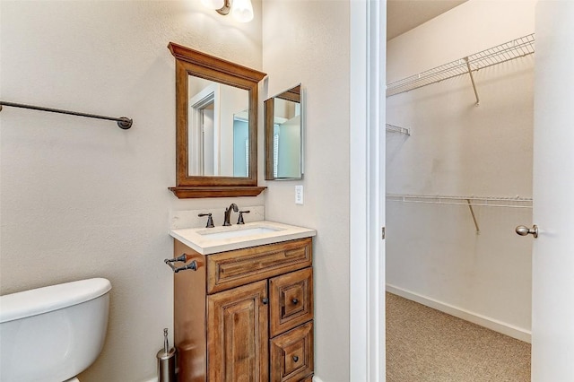 1201 Grove Blvd Unit 2403, Austin, TX 78741 - bathroom with a walk in closet, toilet, and vanity