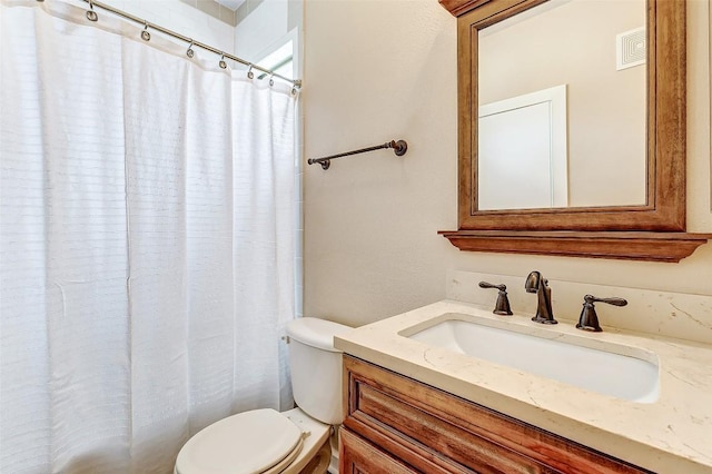 1201 Grove Blvd Unit 2403, Austin, TX 78741 - bathroom with toilet, vanity, curtained shower, and visible vents