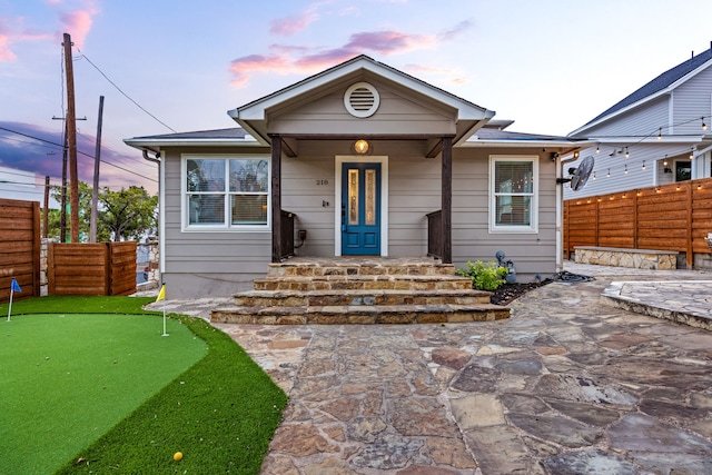 bungalow-style home with a patio area