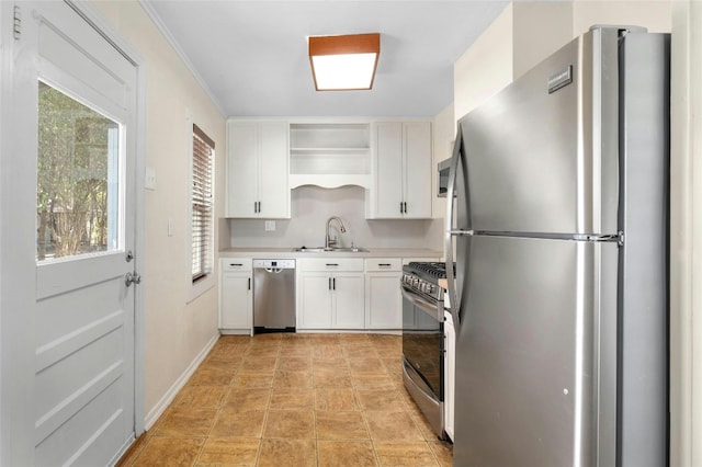 kitchen with stainless steel appliances, ornamental molding, sink, and white cabinets