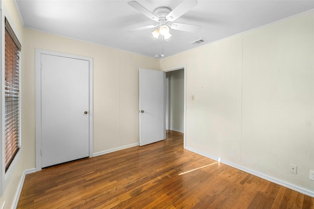 4804 Tanney St, Austin, TX 78721 - unfurnished bedroom featuring wood finished floors, baseboards, and ceiling fan