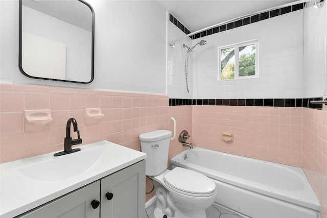 4804 Tanney St, Austin, TX 78721 - bathroom with toilet, shower / bathtub combination, tile walls, and vanity