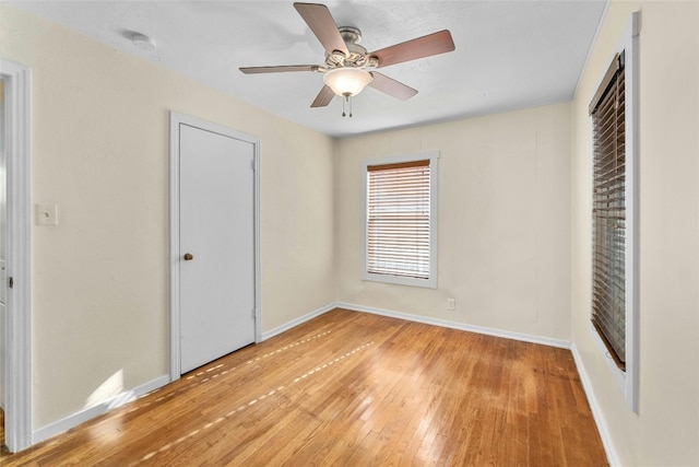 unfurnished bedroom with ceiling fan and light hardwood / wood-style flooring