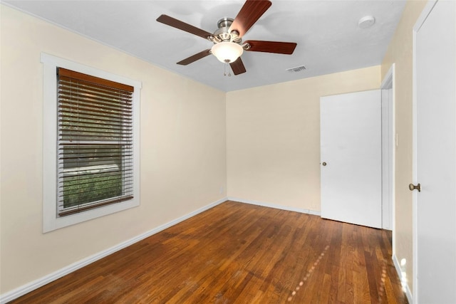 spare room featuring ceiling fan and dark hardwood / wood-style flooring