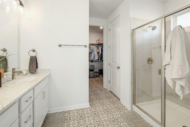 bathroom featuring vanity, tile patterned floors, and a shower with door