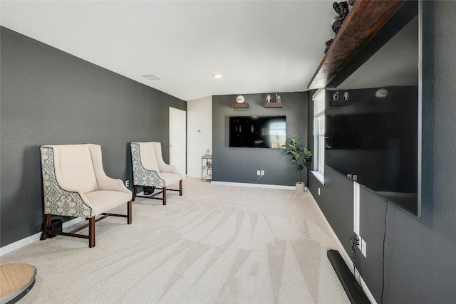 sitting room featuring light colored carpet