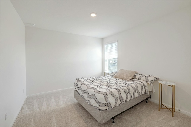 bedroom featuring light colored carpet