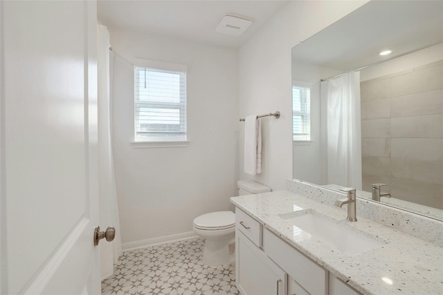 bathroom featuring toilet, curtained shower, and vanity