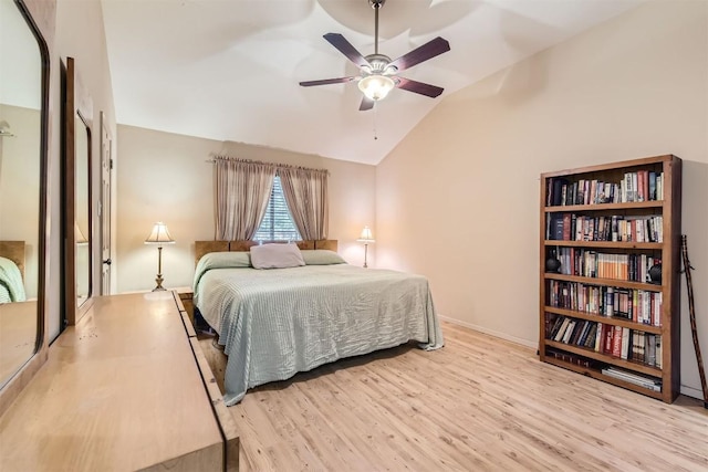 bedroom featuring ceiling fan, light wood-type flooring, and vaulted ceiling