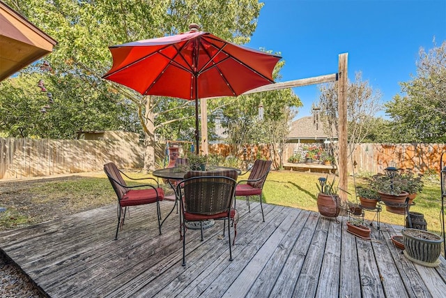 wooden deck featuring a lawn