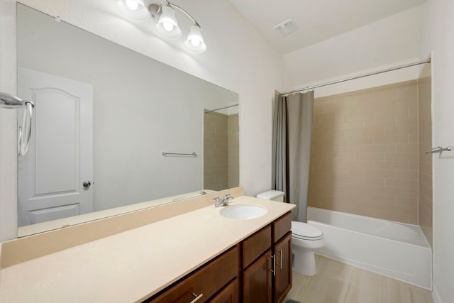 full bathroom featuring vanity, shower / tub combo with curtain, and toilet