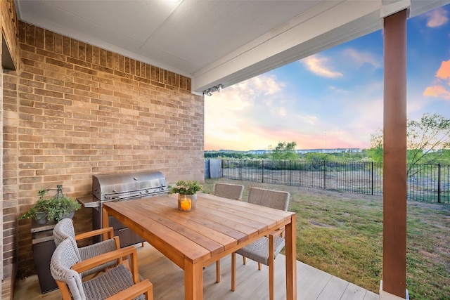 exterior space with a wooden deck, area for grilling, grilling area, and a lawn