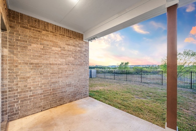 yard at dusk with a patio area