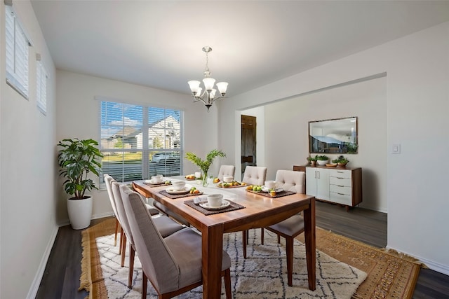 dining space featuring an inviting chandelier and dark hardwood / wood-style floors