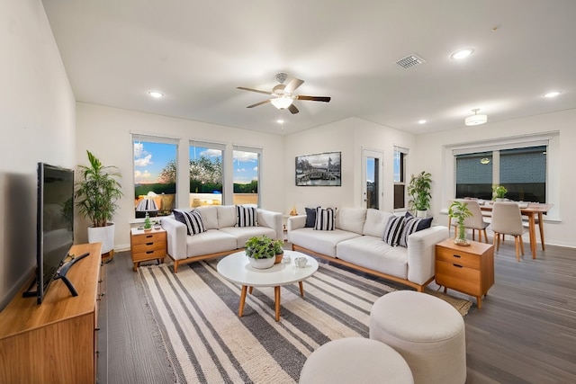 living room with ceiling fan and dark hardwood / wood-style flooring