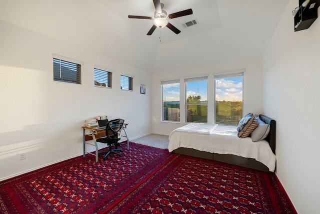 carpeted bedroom with high vaulted ceiling and ceiling fan