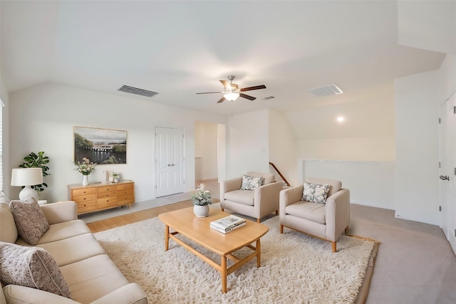 living room with vaulted ceiling, light colored carpet, and ceiling fan