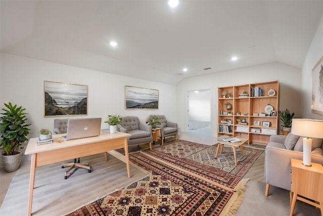 office with lofted ceiling and light wood-type flooring