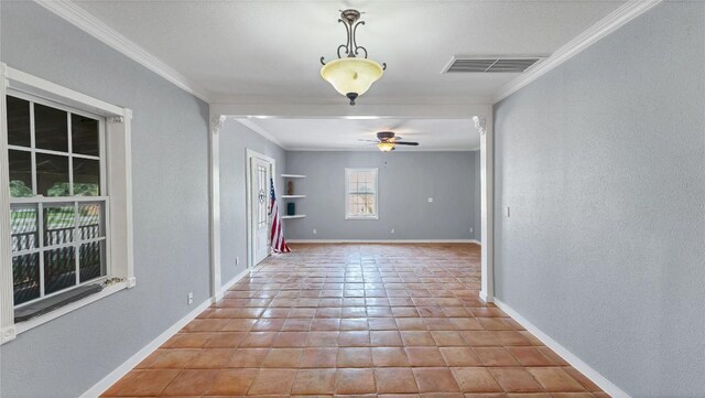 tiled spare room featuring ceiling fan, crown molding, baseboards, and a textured wall