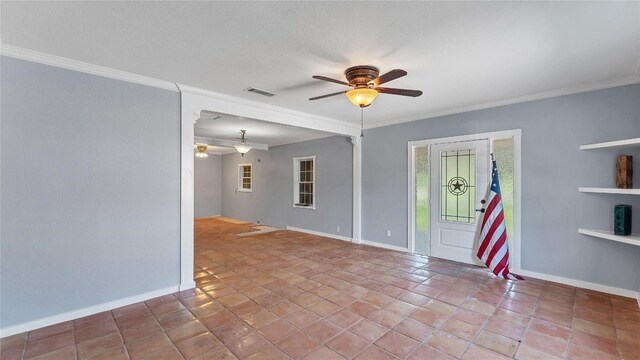 unfurnished room with ceiling fan, baseboards, and crown molding