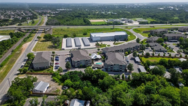 aerial view of property and surrounding area featuring nearby suburban area