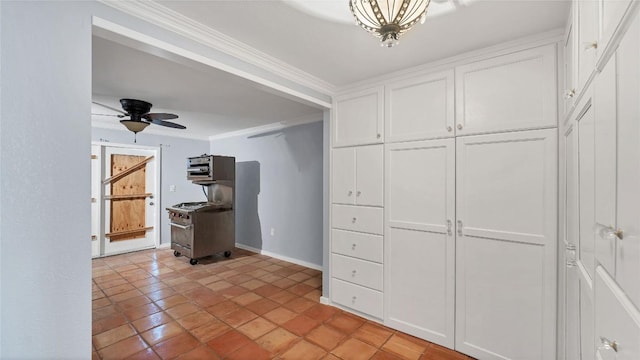 kitchen featuring white cabinets, crown molding, baseboards, ceiling fan, and light tile patterned floors