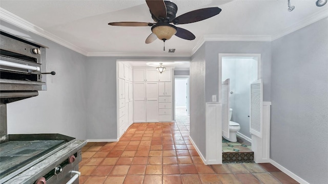interior space with ornamental molding, a ceiling fan, and baseboards