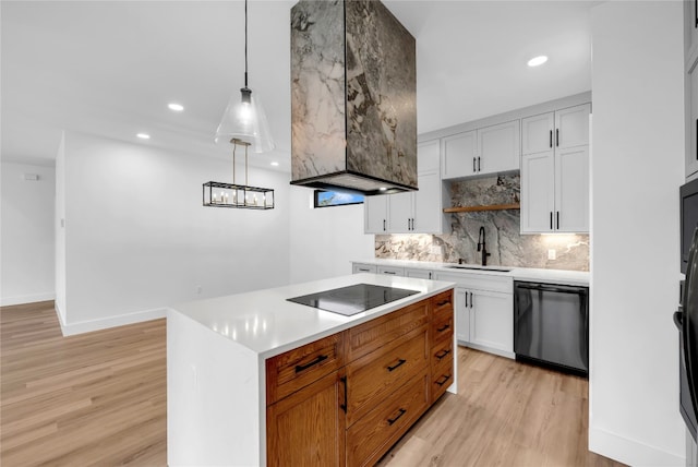 kitchen featuring black appliances, a kitchen island, white cabinetry, light hardwood / wood-style floors, and pendant lighting