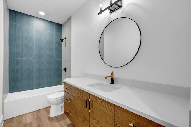 full bathroom with vanity, toilet, tiled shower / bath combo, and wood-type flooring