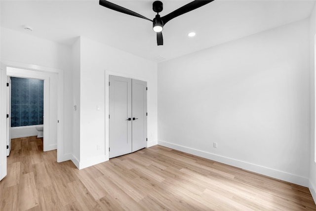 unfurnished bedroom featuring light hardwood / wood-style flooring, a closet, and ceiling fan