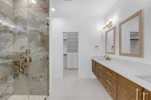 bathroom with vanity, a shower with shower door, and tile patterned flooring