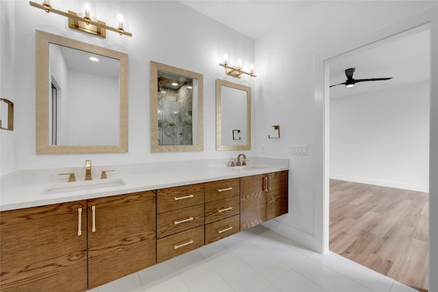 bathroom featuring vanity, ceiling fan, and wood-type flooring