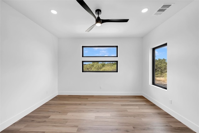 spare room featuring light wood-type flooring and ceiling fan