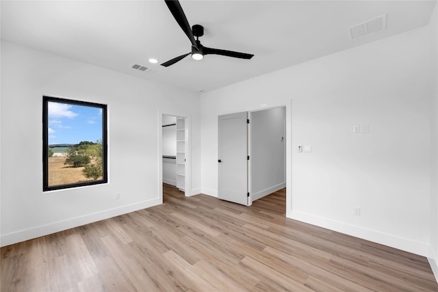 unfurnished bedroom with light wood-type flooring and ceiling fan