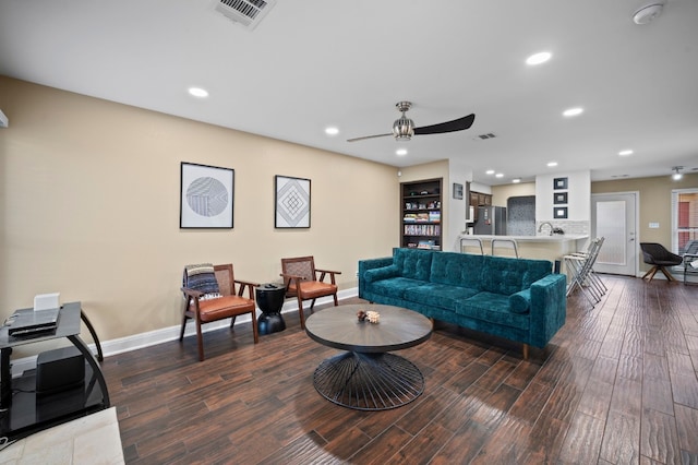 living room featuring hardwood / wood-style floors and ceiling fan