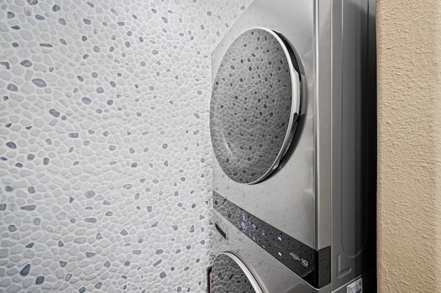 laundry room featuring stacked washer and clothes dryer