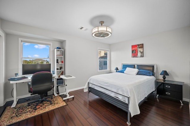 bedroom with dark hardwood / wood-style floors