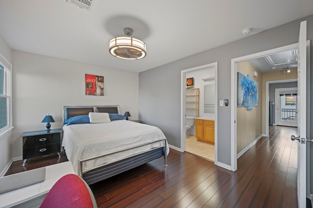 bedroom with dark wood-type flooring and ensuite bathroom