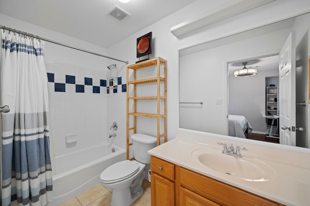 full bathroom featuring toilet, shower / bath combo with shower curtain, vanity, and tile patterned flooring