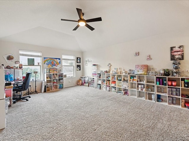 recreation room with ceiling fan, carpet flooring, and vaulted ceiling