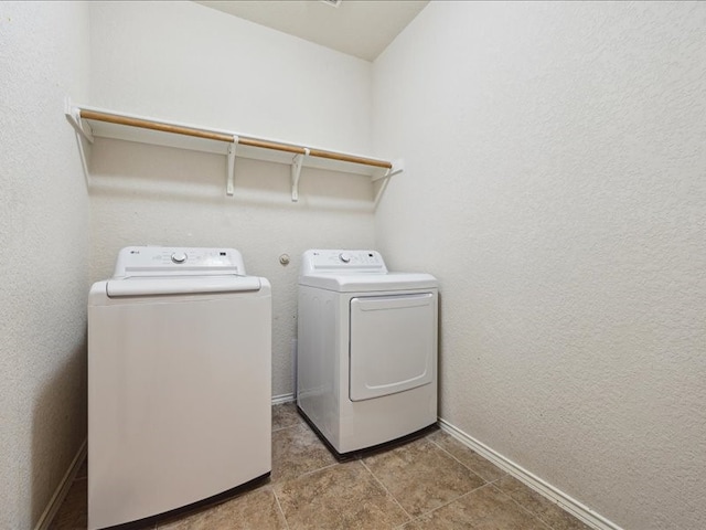 clothes washing area featuring washing machine and dryer and tile patterned flooring