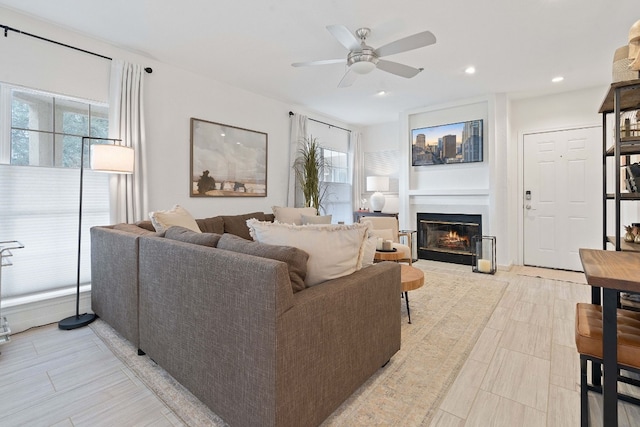 3404 American Dr Unit 2108, Lago Vista, TX 78645 - living area with healthy amount of natural light, a glass covered fireplace, ceiling fan, and recessed lighting